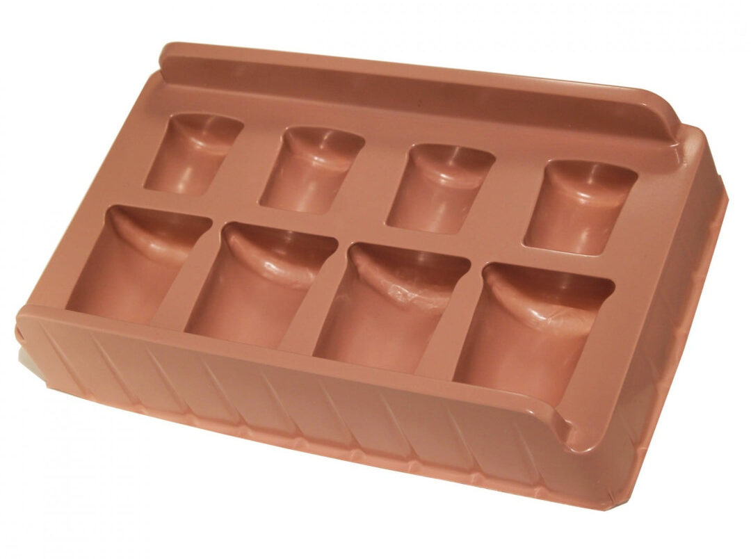 A brown vacuum formed tray insert for candle packaging.